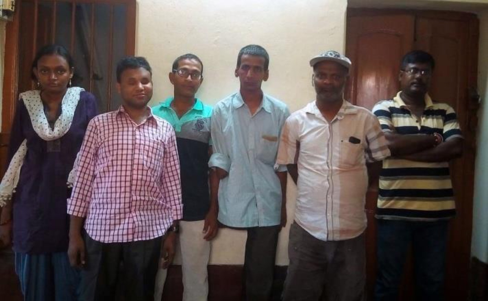 Six DAND trainees and team members standing together in the DAND office.